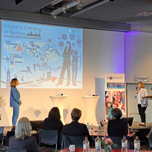 Initiatorin Friedericke C. Kühn und Moderatorin Andrea Peters beenden die Veranstaltung mit der Zeichnung der Grafikerin im Hintergrund.